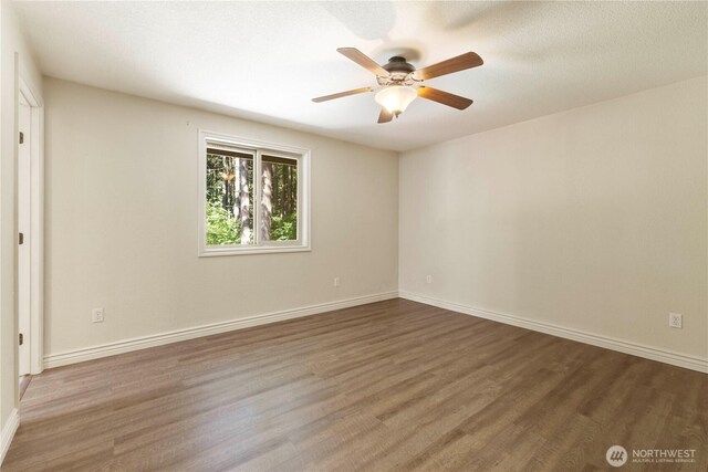7511 Kittiwake Dr SE, Olympia, WA 98513 - unfurnished room with wood finished floors and ceiling fan