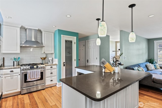 14618 SE 275th Pl, Kent, WA 98042 - kitchen with gas stove, wall chimney range hood, open floor plan, white cabinets, and light wood-style flooring