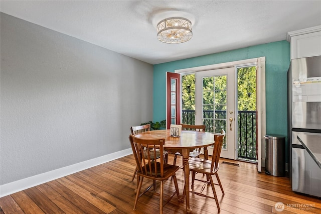 14618 SE 275th Pl, Kent, WA 98042 - dining area with hardwood / wood-style flooring, a textured wall, and a chandelier