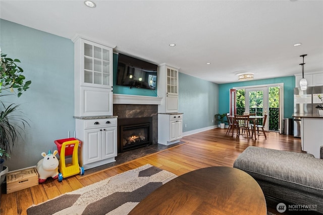 14618 SE 275th Pl, Kent, WA 98042 - living area featuring light wood-type flooring, a tiled fireplace, and recessed lighting