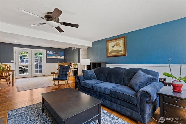 14618 SE 275th Pl, Kent, WA 98042 - living room featuring wood finished floors, a wainscoted wall, a ceiling fan, and french doors