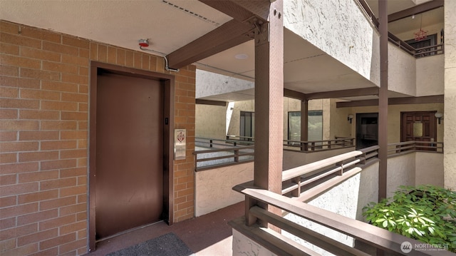 11021 Glen Acres Dr S Unit B, Seattle, WA 98168 - property entrance featuring elevator, brick siding, and a balcony