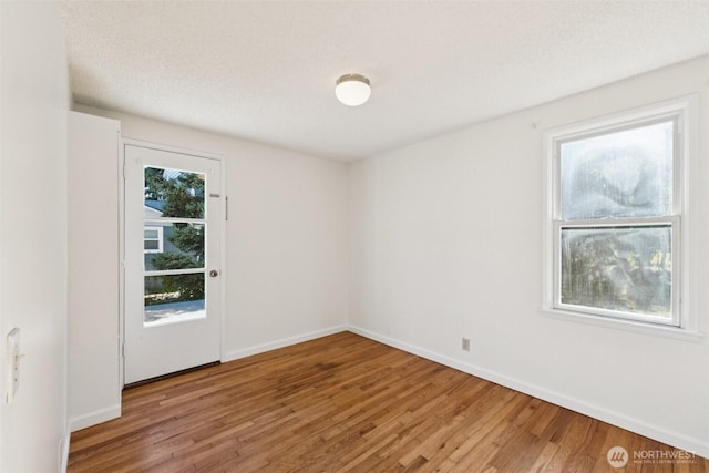 14326 Meridian Ave N, Seattle, WA 98133 - unfurnished room featuring wood finished floors and baseboards