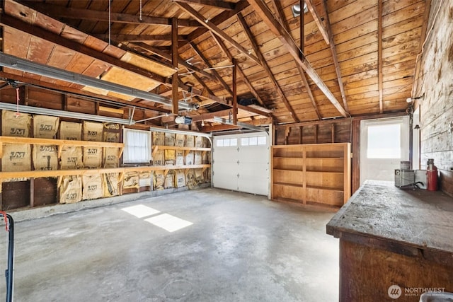 14326 Meridian Ave N, Seattle, WA 98133 - garage featuring wooden ceiling and a garage door opener