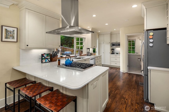 1600 Interlaken Pl E, Seattle, WA 98112 - kitchen featuring extractor fan, appliances with stainless steel finishes, a peninsula, healthy amount of natural light, and recessed lighting