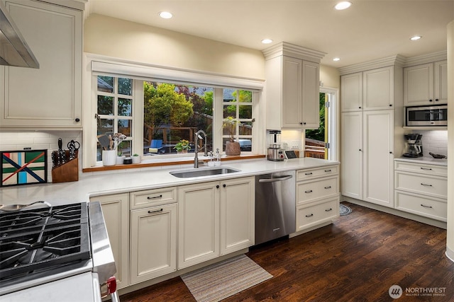 1600 Interlaken Pl E, Seattle, WA 98112 - kitchen featuring appliances with stainless steel finishes, dark wood-style floors, backsplash, recessed lighting, and light countertops
