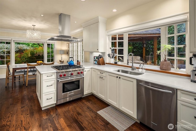1600 Interlaken Pl E, Seattle, WA 98112 - kitchen with stainless steel appliances, island exhaust hood, light countertops, dark wood finished floors, and recessed lighting