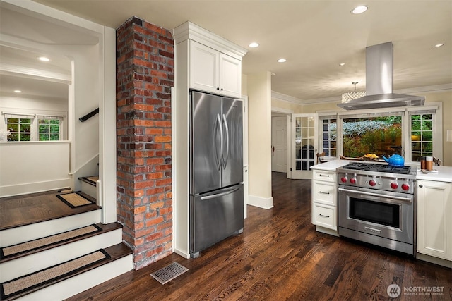 1600 Interlaken Pl E, Seattle, WA 98112 - kitchen featuring stainless steel appliances, island range hood, light countertops, ornamental molding, and white cabinetry