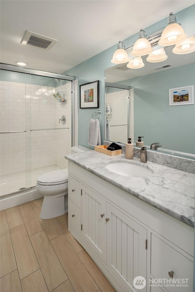 1600 Interlaken Pl E, Seattle, WA 98112 - bathroom with vanity, a shower stall, and wood tiled floors