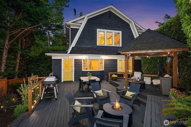1600 Interlaken Pl E, Seattle, WA 98112 - deck at dusk featuring outdoor dining area, a gazebo, and an outdoor living space with a fire pit