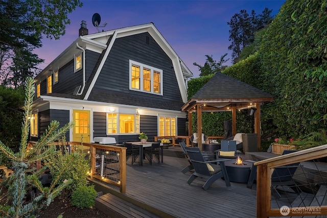 1600 Interlaken Pl E, Seattle, WA 98112 - deck at dusk with a gazebo, an outdoor fire pit, and outdoor dining area