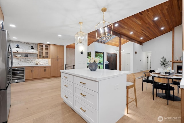 9320 Hoeder Ln, Bothell, WA 98011 - kitchen with wine cooler, a chandelier, freestanding refrigerator, recessed lighting, and light wood finished floors