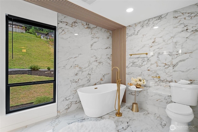9320 Hoeder Ln, Bothell, WA 98011 - full bathroom with marble tiled floors, a freestanding bath, stone wall, recessed lighting, and tile walls