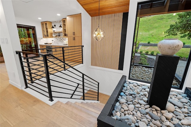 9320 Hoeder Ln, Bothell, WA 98011 - stairs with a chandelier, wood finished floors, and recessed lighting