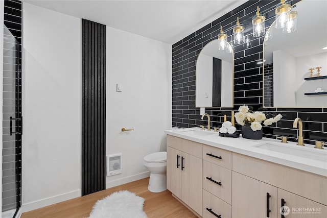 9320 Hoeder Ln, Bothell, WA 98011 - bathroom with double vanity, wood finished floors, tasteful backsplash, and heating unit