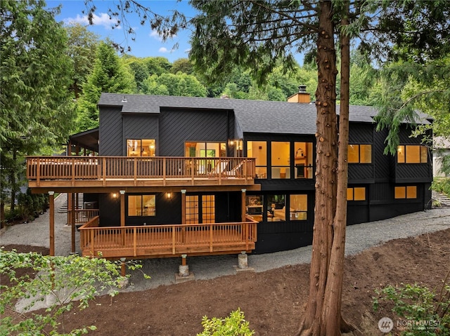 9320 Hoeder Ln, Bothell, WA 98011 - back of house featuring a shingled roof, a wooden deck, and a chimney