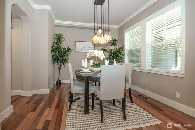 12530 68th Ave SE, Snohomish, WA 98296 - dining space featuring crown molding, wood finished floors, and a chandelier