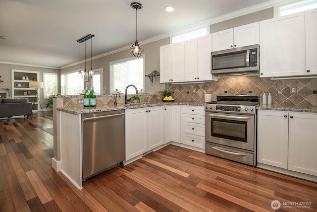 12530 68th Ave SE, Snohomish, WA 98296 - kitchen featuring appliances with stainless steel finishes, open floor plan, white cabinetry, dark wood-style floors, and a peninsula