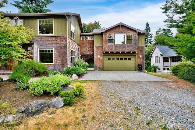 14450 Austin Pl, Anacortes, WA 98221 - view of front facade featuring gravel driveway, an attached garage, and board and batten siding