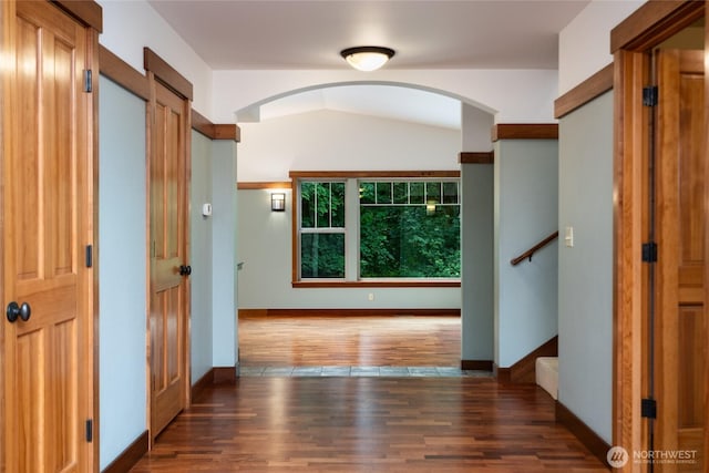 14450 Austin Pl, Anacortes, WA 98221 - hallway with arched walkways, wood finished floors, and stairway