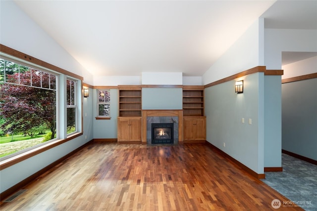 14450 Austin Pl, Anacortes, WA 98221 - unfurnished living room featuring lofted ceiling, wood finished floors, and a fireplace