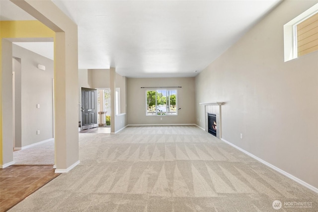 5723 66th Ave SE, Lacey, WA 98513 - unfurnished living room featuring light carpet and a fireplace
