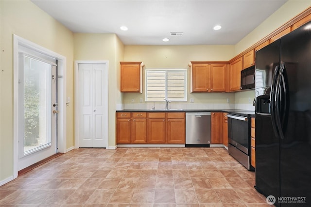 5723 66th Ave SE, Lacey, WA 98513 - kitchen with black appliances, dark countertops, brown cabinets, and recessed lighting