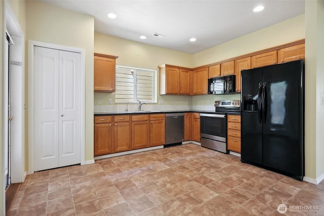 5723 66th Ave SE, Lacey, WA 98513 - kitchen featuring black appliances, recessed lighting, dark countertops, and brown cabinetry
