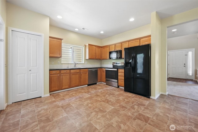 5723 66th Ave SE, Lacey, WA 98513 - kitchen with black appliances, recessed lighting, dark countertops, and brown cabinets
