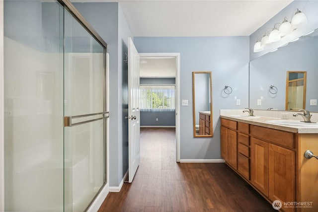 5723 66th Ave SE, Lacey, WA 98513 - bathroom featuring wood finished floors, a shower stall, and double vanity