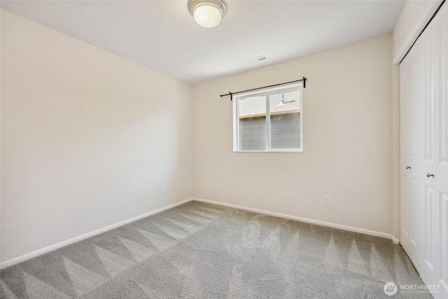 5723 66th Ave SE, Lacey, WA 98513 - unfurnished bedroom with a closet and carpet flooring