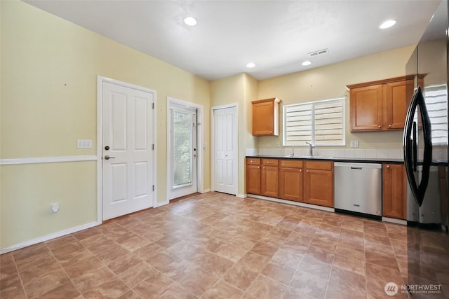 5723 66th Ave SE, Lacey, WA 98513 - kitchen with stainless steel dishwasher, freestanding refrigerator, brown cabinetry, dark countertops, and recessed lighting