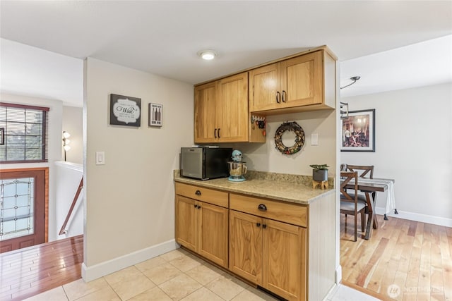 1435 S 263rd Pl, Des Moines, WA 98198 - kitchen featuring light stone counters and light wood-type flooring