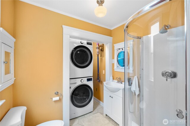 1531 NW 62nd St, Seattle, WA 98107 - washroom featuring stacked washer and clothes dryer, light tile patterned floors, and ornamental molding
