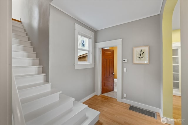 1531 NW 62nd St, Seattle, WA 98107 - entrance foyer with arched walkways, stairway, and light wood-type flooring