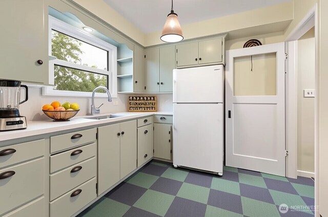 239 S 58th St, Tacoma, WA 98408 - kitchen featuring freestanding refrigerator, dark floors, light countertops, open shelves, and pendant lighting