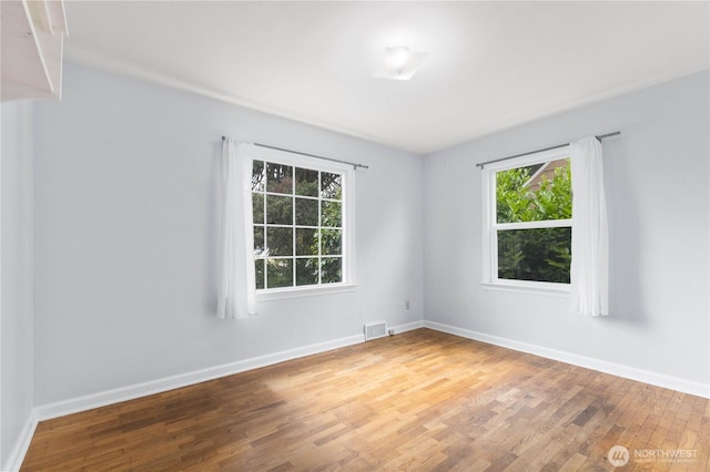 239 S 58th St, Tacoma, WA 98408 - spare room featuring wood finished floors and baseboards