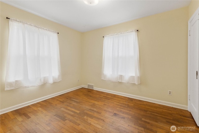 239 S 58th St, Tacoma, WA 98408 - spare room featuring plenty of natural light and wood-type flooring