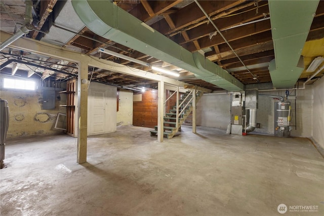 239 S 58th St, Tacoma, WA 98408 - below grade area featuring stairs, heating unit, strapped water heater, and electric panel