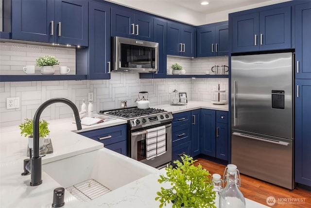 7549 SE 29th St Unit 305, Mercer Island, WA 98040 - kitchen with appliances with stainless steel finishes, open shelves, blue cabinets, and recessed lighting