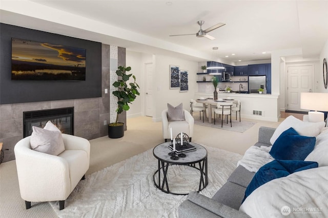 7549 SE 29th St Unit 305, Mercer Island, WA 98040 - living area with ceiling fan, light colored carpet, a tile fireplace, and recessed lighting