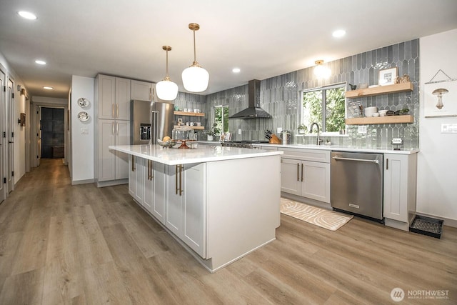 13512 106th Dr SE, Snohomish, WA 98296 - kitchen with stainless steel appliances, open shelves, wall chimney range hood, light countertops, and light wood-style floors