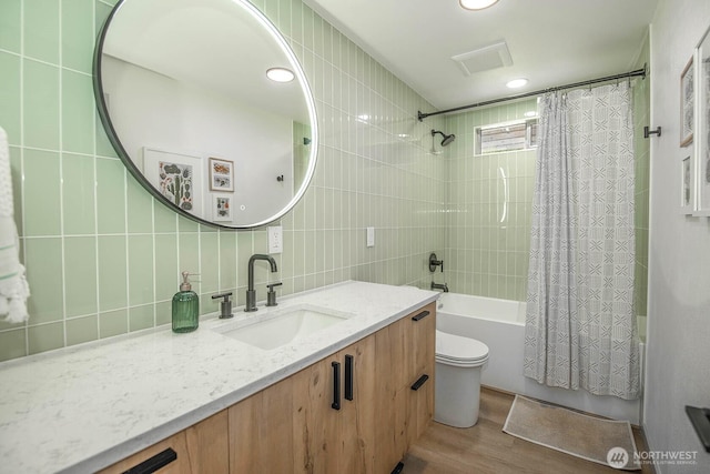13512 106th Dr SE, Snohomish, WA 98296 - full bath with tile walls, shower / tub combo, vanity, wood finished floors, and decorative backsplash