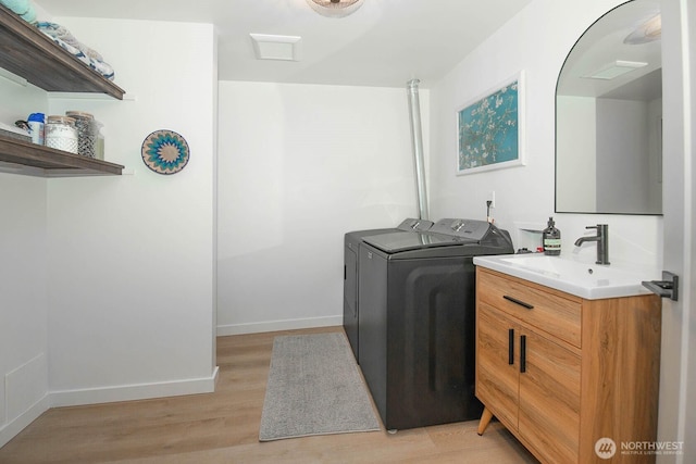 13512 106th Dr SE, Snohomish, WA 98296 - washroom with light wood finished floors and washer and clothes dryer