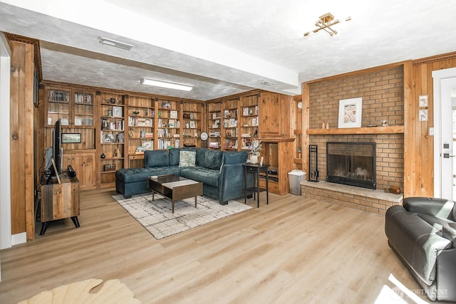 13512 106th Dr SE, Snohomish, WA 98296 - living room featuring wooden walls, wood finished floors, and a brick fireplace