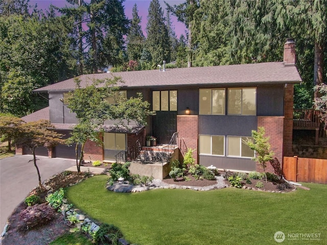 13512 106th Dr SE, Snohomish, WA 98296 - view of front facade featuring a chimney, driveway, an attached garage, and brick siding