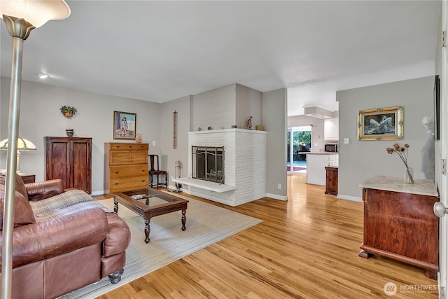 3738 S 189th Pl, Seatac, WA 98188 - living room featuring light wood-style floors and a brick fireplace