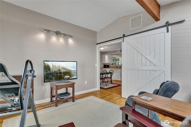 3738 S 189th Pl, Seatac, WA 98188 - exercise room with lofted ceiling, a barn door, and wood finished floors