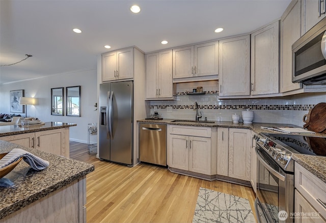 524 Maple St Unit 105, Edmonds, WA 98020 - kitchen featuring appliances with stainless steel finishes, tasteful backsplash, light wood-type flooring, recessed lighting, and crown molding