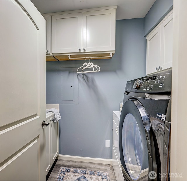 524 Maple St Unit 105, Edmonds, WA 98020 - laundry room with cabinet space, washing machine and clothes dryer, wood finished floors, and electric panel